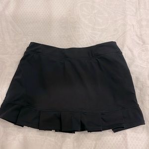 Women’s black pleated 13 inch skort.  Good Used Condition. Size small.